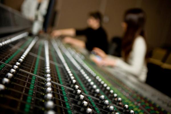 People working on a sound mixing desk