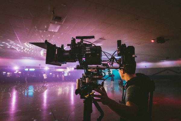 Film camera man in a nightclub scene